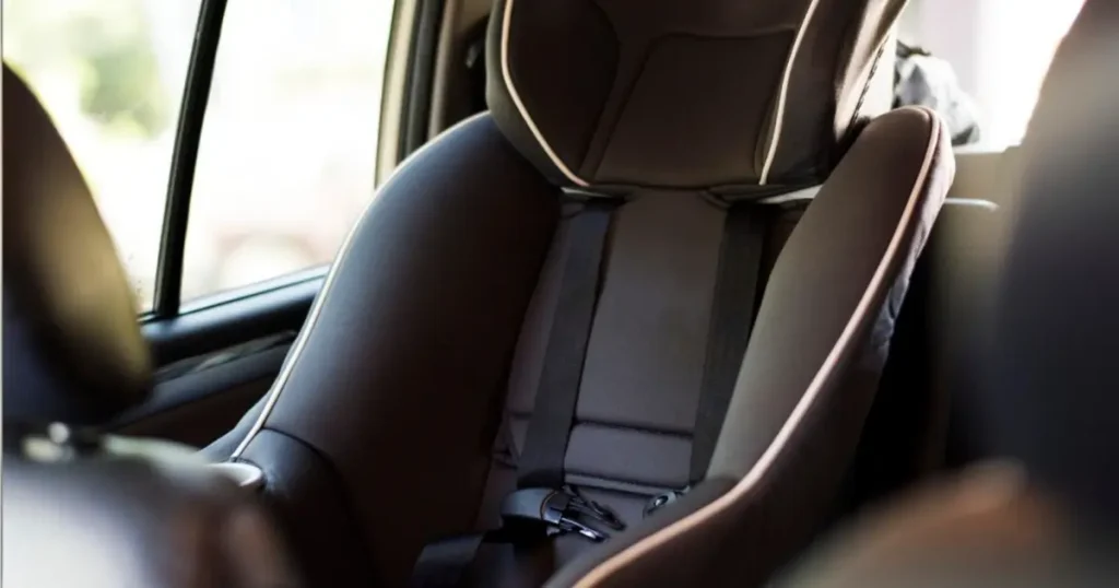 Close-up of a child car seat installed in a car, showcasing proper fit and safety features