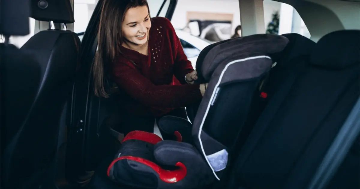 A mother happily learning to install and use the baby car seat properly emphasizing the importance of proper installation for safety.