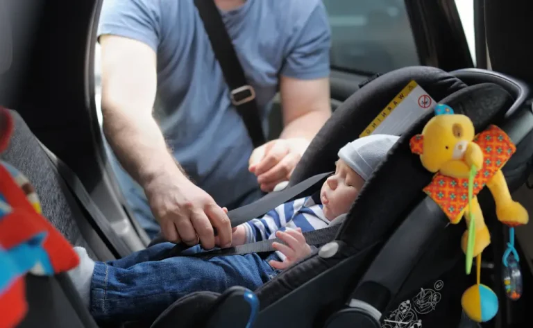 An infant car seat installed in a rear-facing position for optimal child safety.