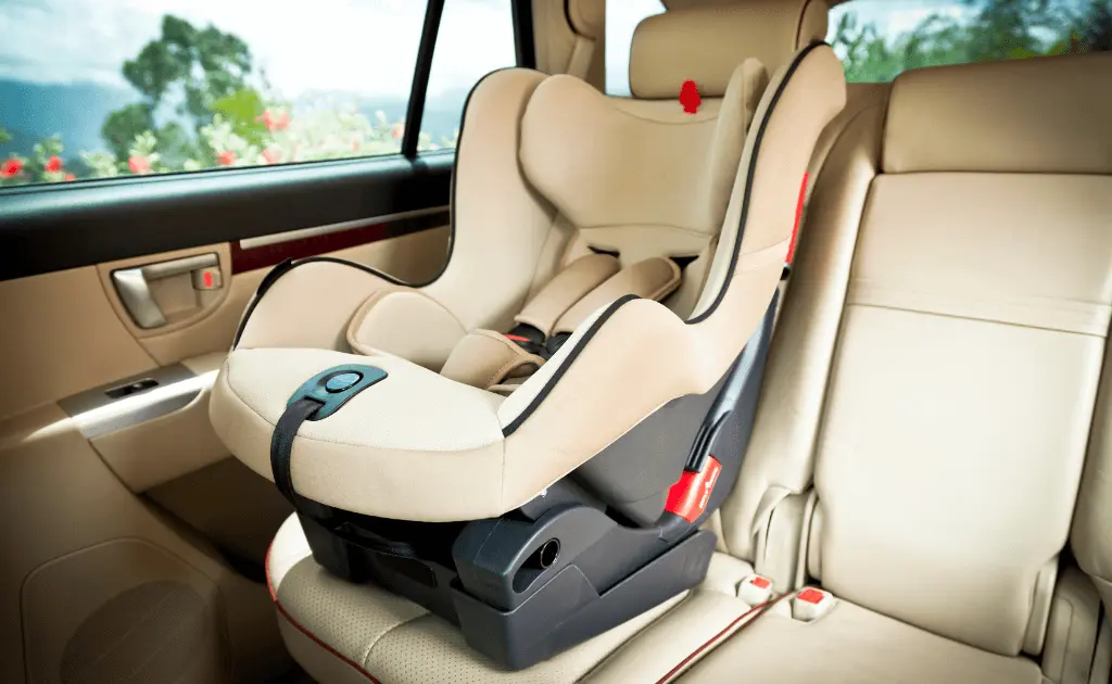 A convertible car seat securely installed in the back seat of a vehicle in forward-facing position.
