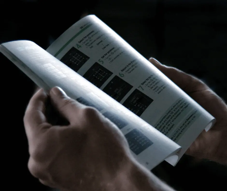 A parent reading the manual before installing a combination car seat.