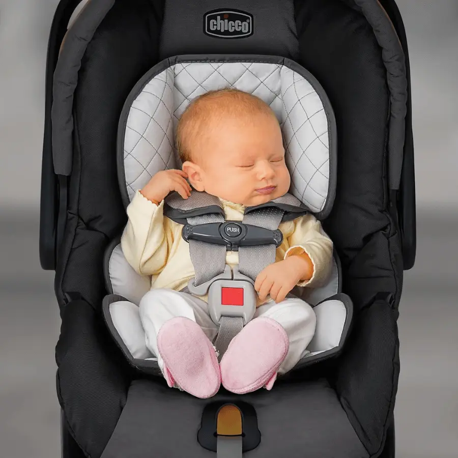 Newborn safely secured in Chicco KeyFit 30 infant car seat with head and body support