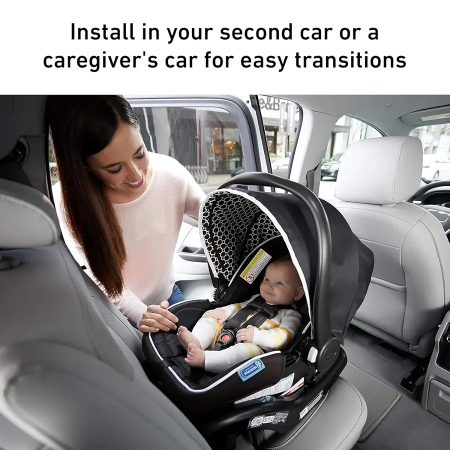 Mother securing baby in an infant car seat base for easy transitions between cars.