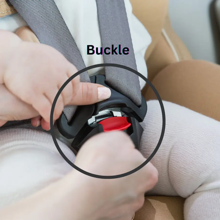 Close-up of infant car seat buckle being fastened for baby safety.